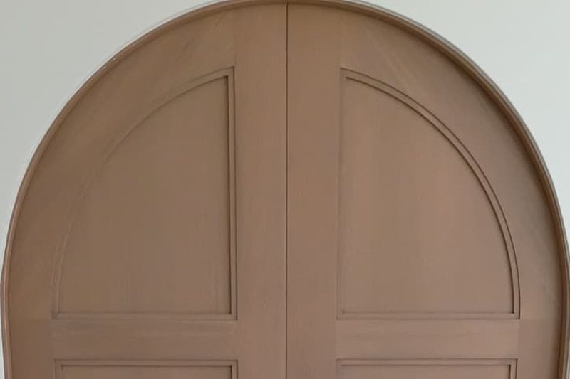 Detail of the curve on an arched white oak door